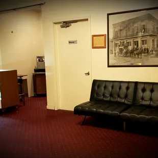 a black leather couch in a waiting room