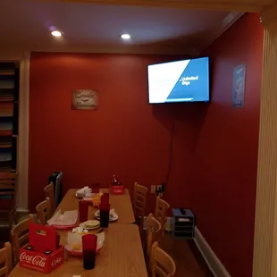 a long dining table with a flat screen tv