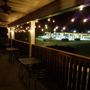 a patio with tables and chairs
