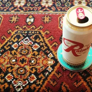 a can of beer on a rug