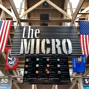 a sign with american flags hanging from the ceiling