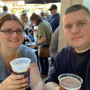 a man and a woman sitting at a table with drinks