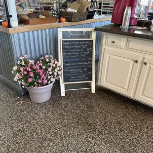 a chalkboard sign and flowers