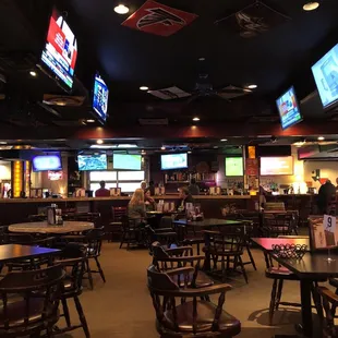 a sports bar with multiple screens