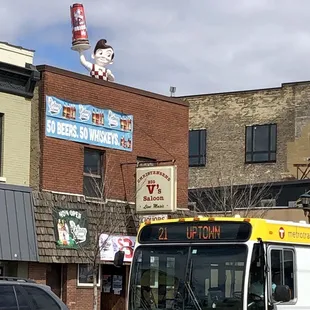 a yellow and white bus driving down the street