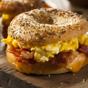 a bagel sandwich with eggs and bacon