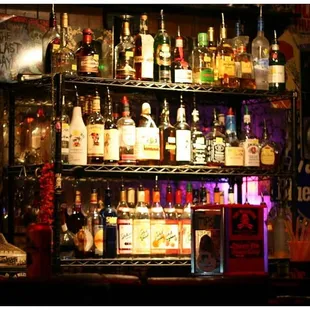 a shelf full of liquor bottles