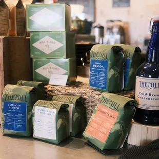 a variety of coffee bags and a bottle of beer