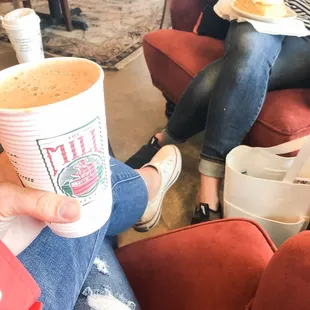 a woman holding a cup of coffee