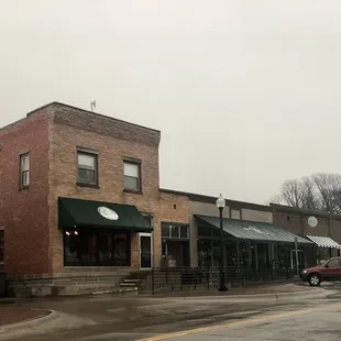 a brick building with a green awning