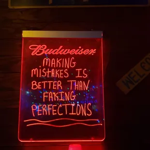 a neon sign with a quote