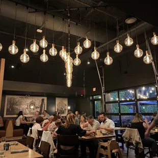 a large group of people sitting at tables in a restaurant