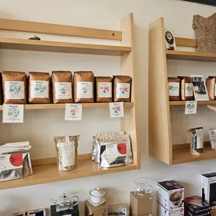 a man standing in front of shelves of coffee