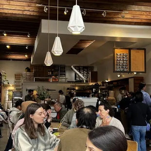 Crowded with a large communal table and a few smaller ones