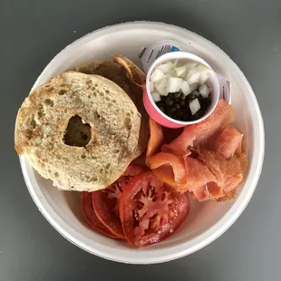 Bagel and lox with cream cheese, capers, tomato and onion