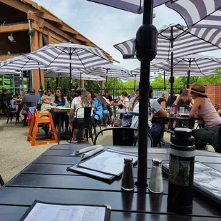 Fantastic patio. Great ambiance, nicely spaced, long tall family table, umbrellas, comfortable metal seats. 7-14-24