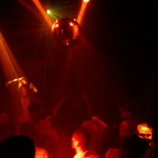 a crowd of people dancing at a nightclub