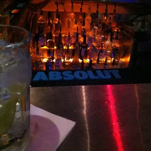 a glass of alcohol and a bar