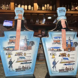 two bottles of liquor on a bar counter