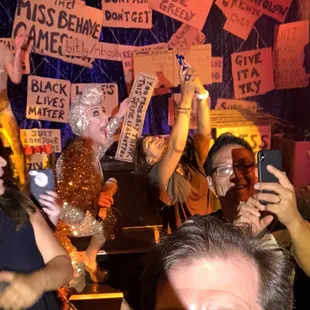 a group of people holding up signs