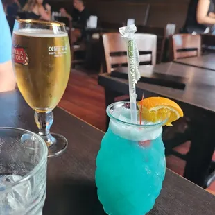 A pretty blue drink and a beer, don&apos;t recall the names of either!