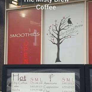 a sign in front of a coffee shop