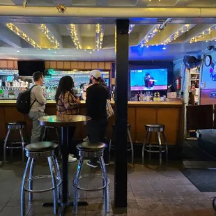 a group of people sitting at a bar