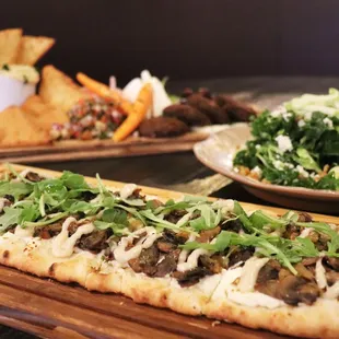 two pizzas and a salad