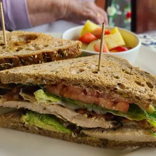 Grilled chicken and avocado sandwich with fresh fruit