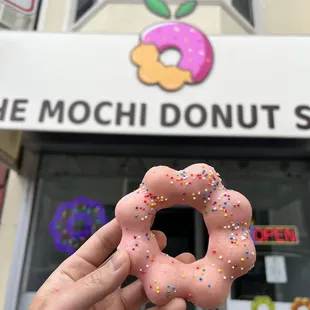 a hand holding a donut