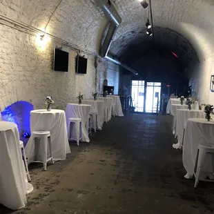 tables and chairs set up in a tunnel