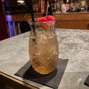 a cocktail in a glass on a bar
