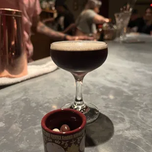 Espresso martini with chocolate coffee beans to pair with