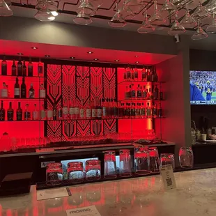 a bar with red lighting