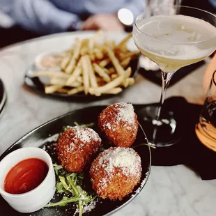Truffle fries in the back and taleggio arancini in front