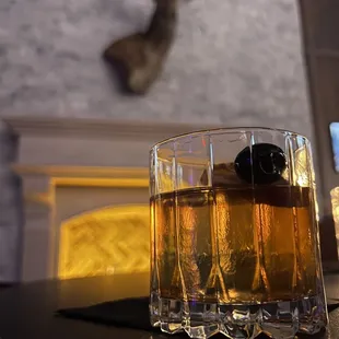a glass of whiskey on a table