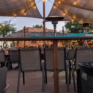 a woman standing on a patio with a trash can