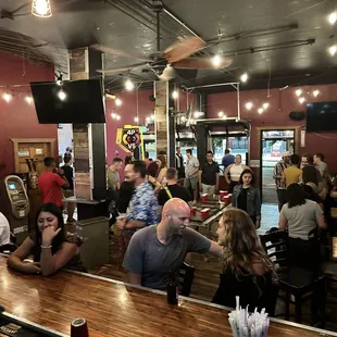 a large group of people sitting at the bar