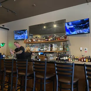 a bar with people sitting at the bar