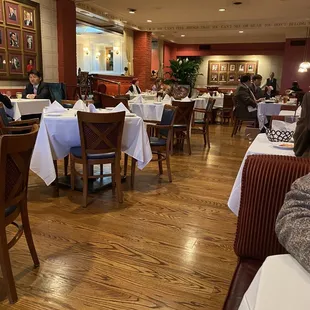 people sitting at tables in a restaurant