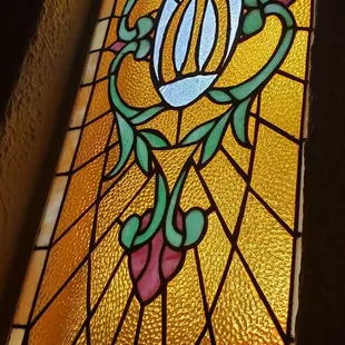 a stained glass window with the letter d