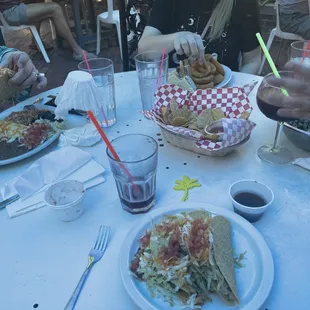 Chicken enchilada, club with onion rings, Caesar salad, blueberry margarita, tacos