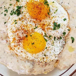 Biscuits and gravy with 2 sunnyside up eggs