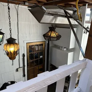 View from back patio seating down to the rear door of the house, leading to the bar and inside dining area.