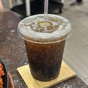 a cup of iced coffee on a table