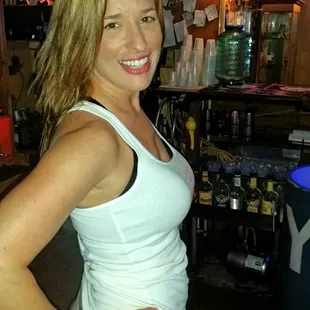 a woman standing in front of a bar