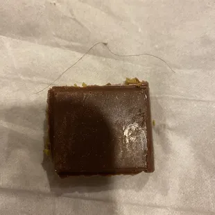 Dubai chocolate bar hair was stuck inside. I&apos;m bummed it was a good first bites. Then found this in the middle of the bar. 12/2024