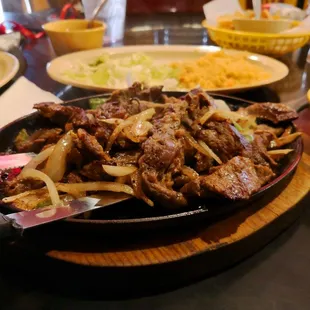 a plate of beef and onions