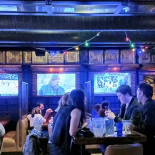 a group of people sitting at a bar