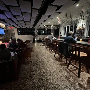 a group of people sitting at a bar